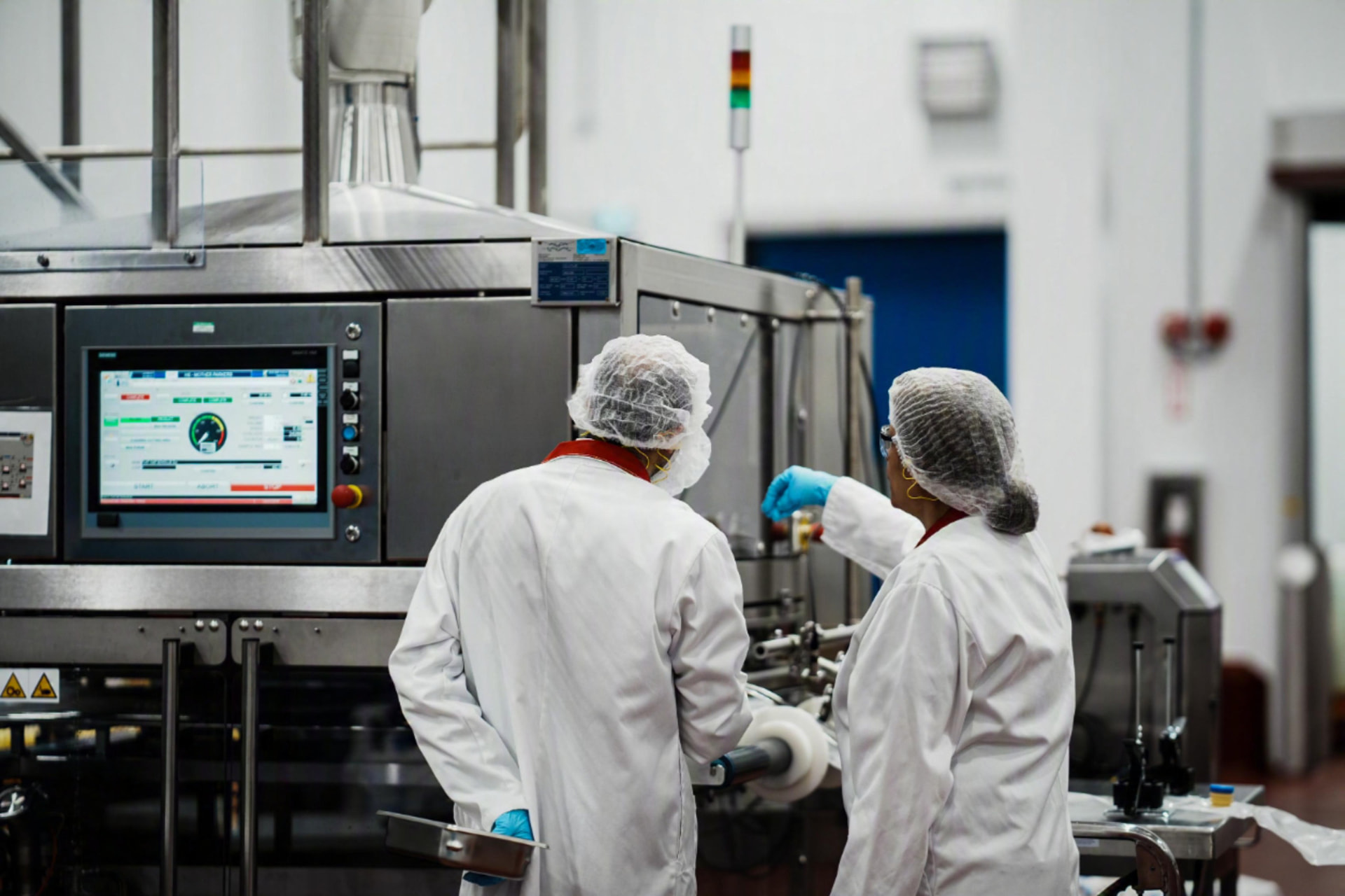 Mother Parkers production line staff reviewing packaging machinery
